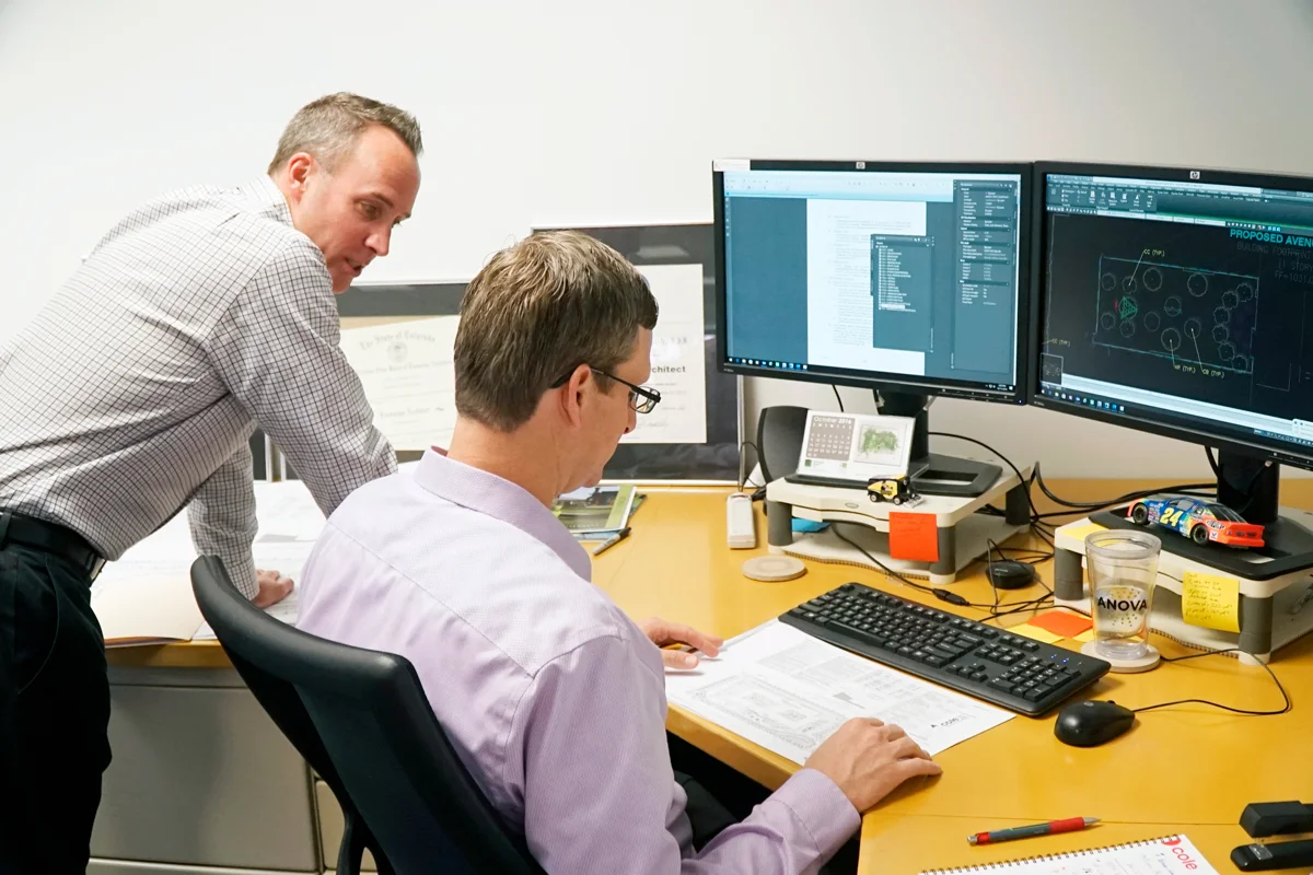 Colleagues collaborating over a project on a computer screen